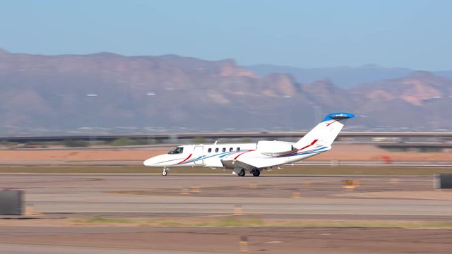 Generic Unmarked Private Jet on a Desert Runway with Mountains in the Background on a Sunny Day in the South Western United States