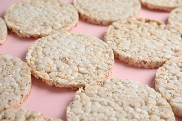 Crunchy rice cakes on color background, closeup