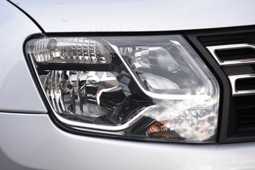 Obraz premium shiny headlights on a white car