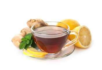 Cup of tea, ginger, mint and lemons on white background. Cough remedies