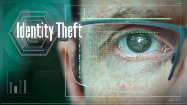A close up of a businessman eye controlling a futuristic computer system with a Business Identity Theft concept.