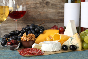 Composition with wine and snacks on table