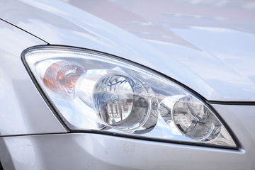 shiny headlights on a silver  car