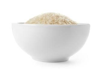 Bowl with uncooked parboiled rice on white background