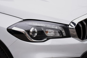 Fototapeta na wymiar shiny headlights on a white car