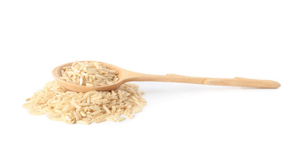 Spoon and uncooked brown rice on white background