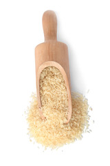 Scoop with uncooked parboiled rice on white background, top view