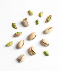 Composition with organic pistachio nuts on white background, top view