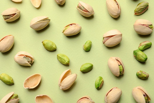 Fototapeta Composition with organic pistachio nuts on color background, flat lay