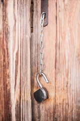 old padlock on a wooden door