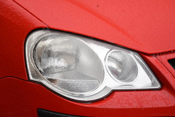  Frozen car headlight,Freezing rain ice coated car. 