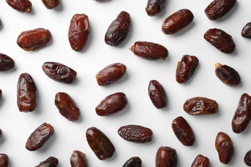 Sweet dates on white background, top view. Dried fruit as healthy snack