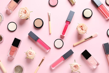 Beautiful composition with lipsticks and flowers on color background, flat lay
