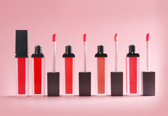 Liquid lipsticks with applicators on color background