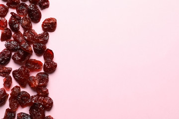 Cranberries on color background, top view with space for text. Dried fruit as healthy snack