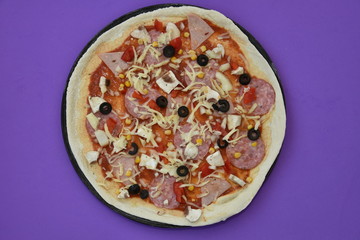 pizza with olives and cheese  on purple
