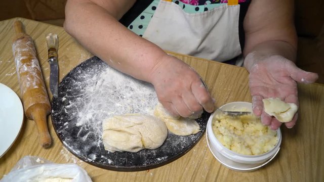 Senior Woman Making Dumplings With Mashed Potatoes Stuffing