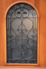 Architectural artistic decorations with wrought iron on old wooden door, in Bistrita