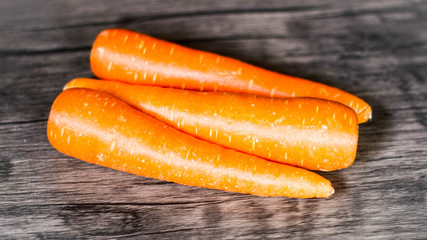 Fresh carrots on wood background.