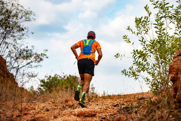 A man Runner of Trail . and athlete's feet wearing sports shoes for trail running in the mountains