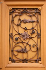 Architectural artistic decorations with wrought iron on old wooden door, in Bistrita