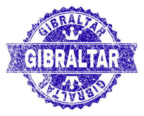 GIBRALTAR rosette stamp seal overlay with grunge texture. Designed with round rosette, ribbon and small crowns. Blue vector rubber print of GIBRALTAR caption with grunge style.