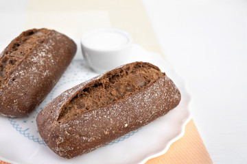Air black buns a white plate, on a white background