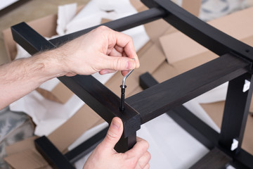 the process of furniture assembly screws closeup