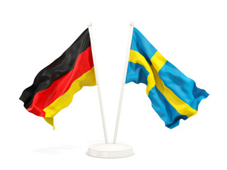 Two waving flags of Germany and sweden