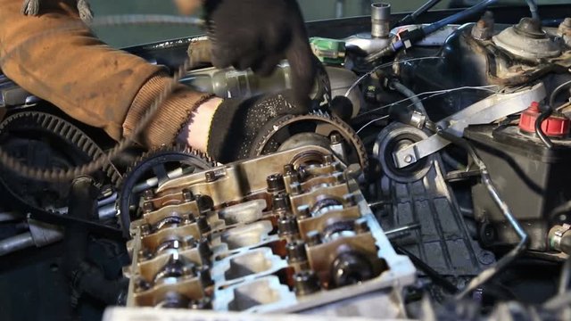 Mechanic repairs the car engine

