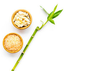 Asian spa procedure with natural ingredients concept. Bamboo branch, spa cosmetics on white background top view space for text