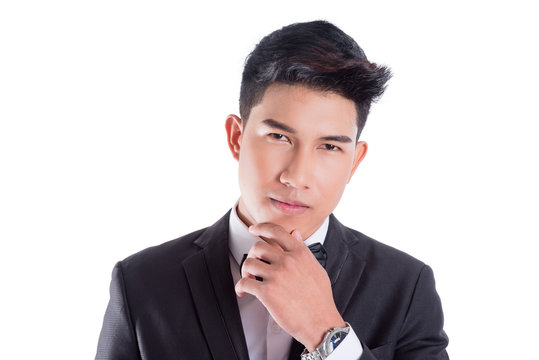 Portrait Of Young Asian Confident Man Dressed In Tuxedo With Bow Tie Isolated On White Background