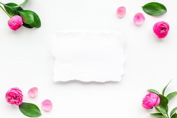 Template for greeting card. Mockup with flowers, petals, leaves, white paper on white background top view frame