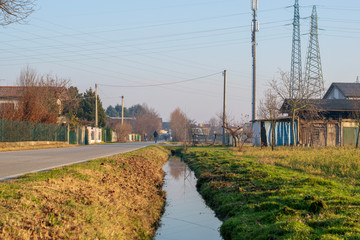 Fototapeta na wymiar water canal and a countryside road