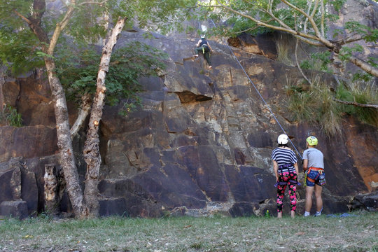 Unrecognizable Young Australian People Abseiling From A Cliff In Brisbane Australia