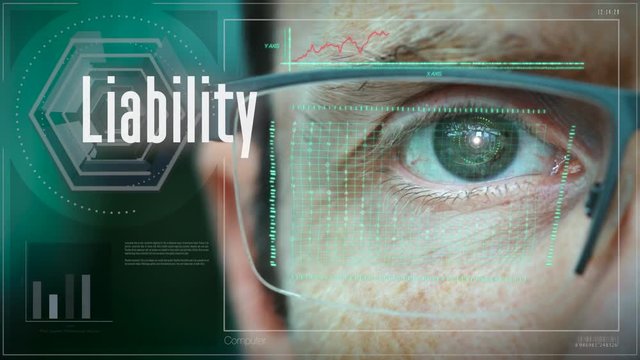 A close up of a businessman eye controlling a futuristic computer system with a Business Liability concept.