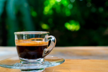 Black coffee or Americano on table with film vintage tone background.