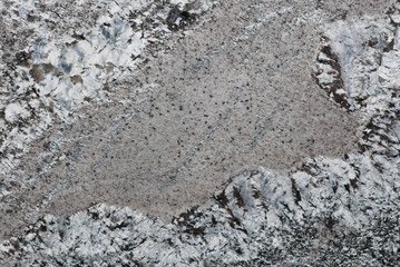 Gray and white and tan marbled granite surface
