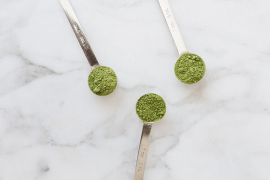 Teaspoons of Matcha on Marble Backdrop