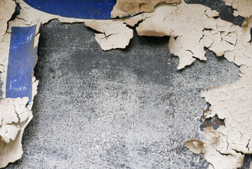 Old peeling paper with blue paint on gray cement wall