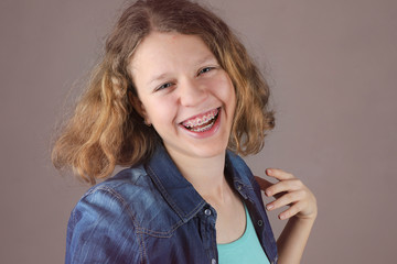 Portrait of beautiful smiling curly hair teens girl.