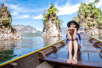 A beautiful asian woman travelling by long tail boat