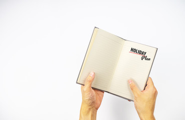 Holiday plan on notebook with hand holding on white background