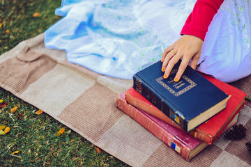 Hand of a Woman who is holding a book