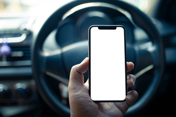 Man hand holding  smartphone with blank screen in the car