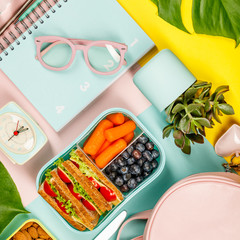 Creative flat lay with healthy lunch and office or school supp