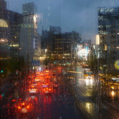 Rainy evening in the city. Raindrops on glass