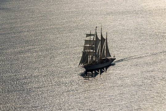 Sailing ship in the back light at Santorini, Santorini, Greece, Europe