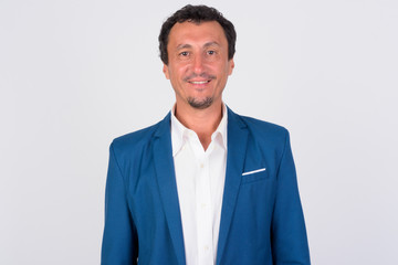 Portrait of happy mature businessman smiling against white background