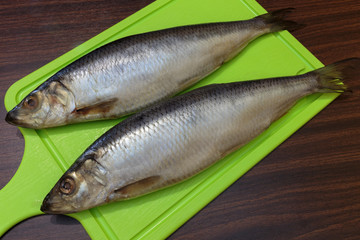 Salted herring on a cutting board.